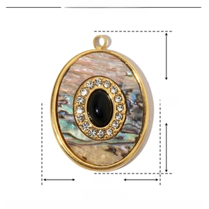 Detail view of oval stainless steel pendant with natural shell and black stone inlay