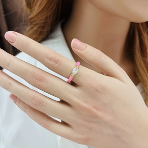 Close-up of gold drip oil enamel ring with pink finish and marquise cut zircon