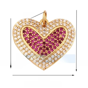 Macro view of a gold-plated heart pendant featuring red gemstones and white zircons