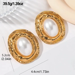 Macro view of gold irregular leaf earrings with white oval pearl and size specifications