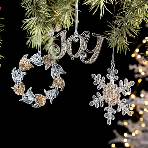 Three-piece acrylic Christmas ornament set with JOY, wreath, and snowflake in gold glitter