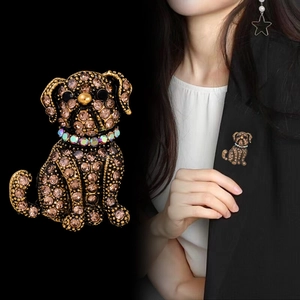 Retro bulldog brooch featuring champagne rhinestones and antique metal finish on a blazer