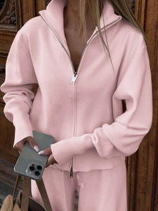 Detail of pink knitted zip-up hoodie with ribbed cuffs and textured knit fabric