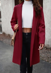 Detail shot of a wine red woolen coat featuring a classic single-breasted design