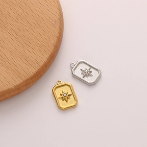 Detailed macro view of gold and silver rectangular star pendants with crystal centers