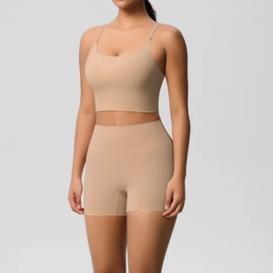 Detail view of seamless high-waist yoga shorts and strappy sports bra in matte nude