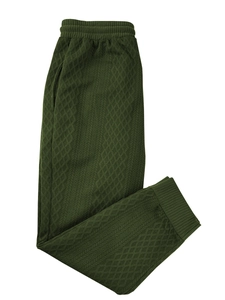Detailed view of dark green knitted joggers featuring a geometric diamond texture design