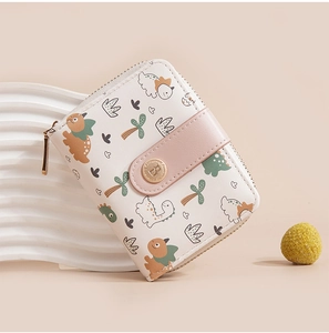 Close-up of white PU leather wallet with cartoon dinosaur print and gold metal zipper