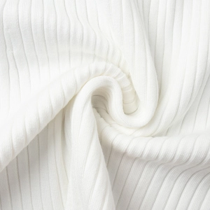 Close-up of white ribbed knit fabric showing soft texture and high elasticity detail