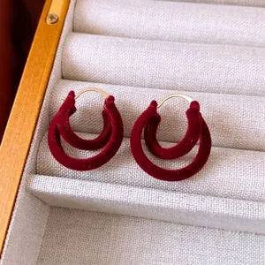 Retro burgundy flocked double circle earrings with gold metal hoops on jewelry box