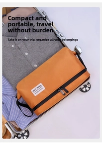 Orange dry-wet separation toiletry bag inside a suitcase with clothes for travel storage