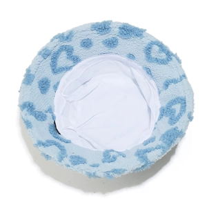 Interior view of light blue fuzzy bucket hat with heart patterns and white fabric lining