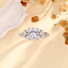 Macro shot of silver ring with large round center gem and sparkling side clusters