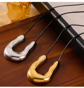 Modern geometric U-shaped titanium steel pendants in gold and silver on black cords