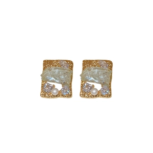 Elegant gold square stud earrings with zircon crystals and faux pearl on white background