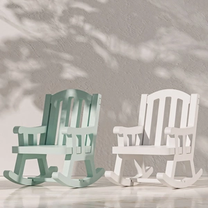 Miniature rocking chair models in mint green and white colors with realistic shadows