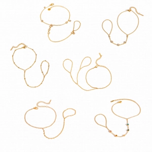 Six assorted gold stainless steel slave bracelets with zircon and pearl accents