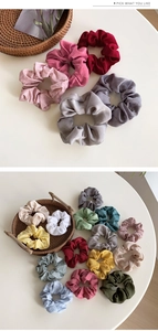 Detail view of colorful satin scrunchies showing glossy fabric texture and vibrant colors