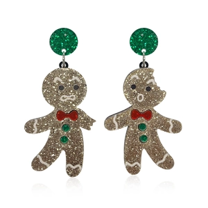 Cute gingerbread man acrylic Christmas earrings with gold glitter and red bow on white background