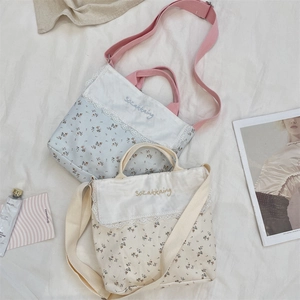 Floral canvas bag detail featuring delicate lace edges and embroidered text on front