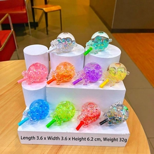 Close-up of colorful acrylic lollipop keychains with floating sequins and star glitters