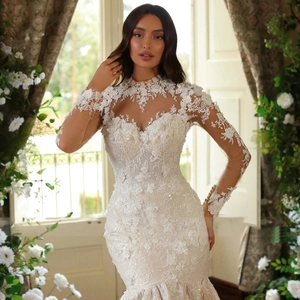 Elegant long sleeve lace mermaid bridal gown with sheer neckline and white floral train