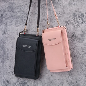 Women's small leather crossbody phone bag in black and pink with zipper closure