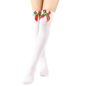 Detail of white over-knee Christmas socks with festive red and green bow decorations