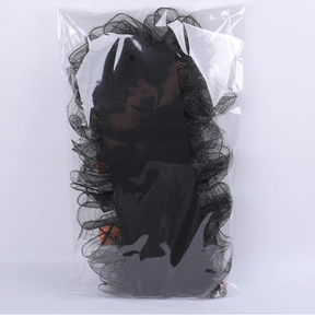Detail of Halloween pumpkin hair accessory with black mesh packaging in clear bag