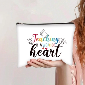 Detail of canvas makeup bag featuring Teaching is a work of heart print and black zipper