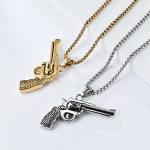 Macro detail of gold and silver stainless steel revolver pendants on box chains