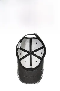 Detail showing internal six-panel structure and 100% cotton label of the baseball cap