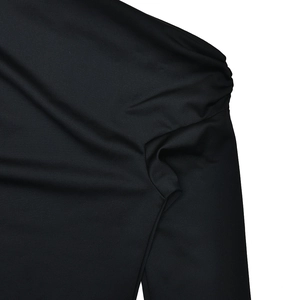 Detail of elegant black ruched shoulder and pleated texture on the long sleeve set