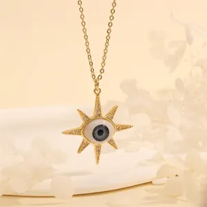 Detail of sunburst Evil Eye pendant with zircons on 18K gold plated chain necklace