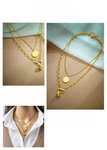 Detail of double-layer gold necklace featuring coin pendant and OT toggle clasp