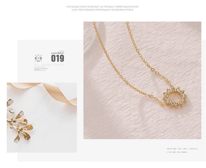 Close-up of golden sunflower pendant with sparkling zircon crystals on an O-chain link