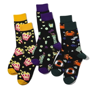 Detailed close-up of three cotton crew socks with popcorn, cocktail, and sea creature prints