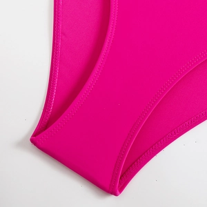 Detailed close-up showing reinforced stitching and matte rose pink fabric of swimwear