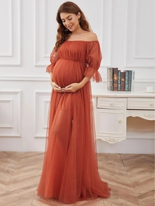 Detail of brick red off-shoulder maternity tulle dress with elegant puff sleeves