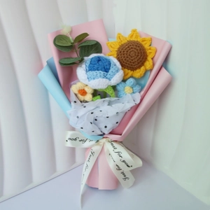 Detail of handcrafted crochet bouquet featuring sunflowers, roses and stylish gift wrap