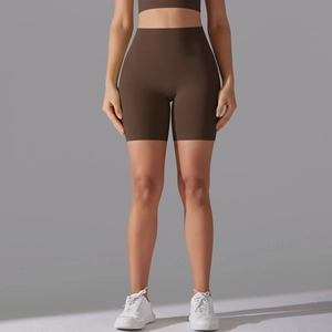 Detail of high-waist seamless yoga shorts in coffee brown with body-sculpting compression
