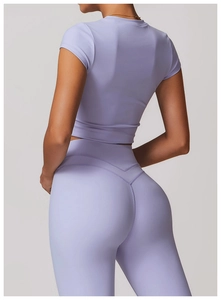 Rear view of lavender yoga crop top and leggings showing body contouring fit and stitching