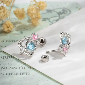 Chic silver cartilage studs with blue heart and pink star gems in a crown design