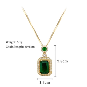 Detail view of a gold titanium necklace with a green pendant and 40+5cm chain size