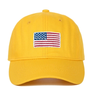 Detailed close-up of high-quality embroidery on a yellow American flag baseball cap
