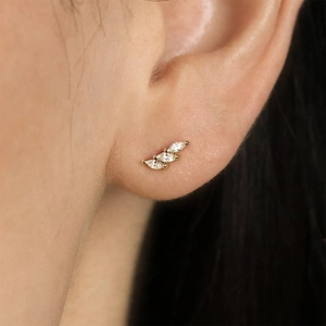 Detailed view of three marquise-cut marquise stones set in gold stud earrings for women