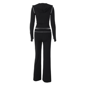 Rear view of black hooded cropped sweatshirt and pants with white contrast stitching