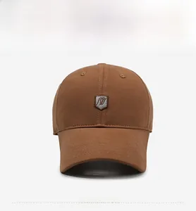 Front view of brown cotton baseball cap featuring a shield logo and curved brim design