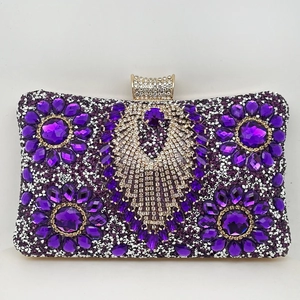 Detailed close-up of a purple rhinestone evening clutch with floral crystal patterns