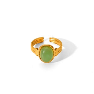 Detail of vintage gold-plated stainless steel ring with green tiger eye oval stone